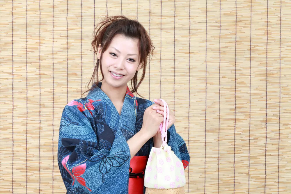 Japanese woman wearing a yukata and holding a bag